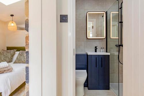 a bathroom with a toilet and a sink and a shower at The Sanctuary Ashover in Chesterfield