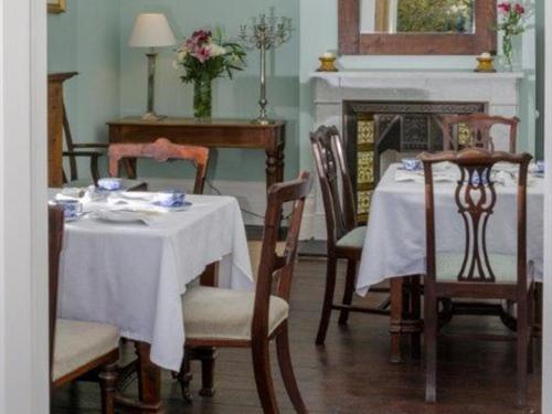 a dining room with a table and chairs and a fireplace at The Lions in Newark upon Trent