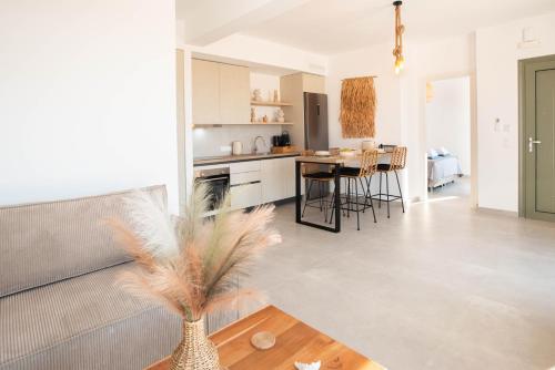 a kitchen and living room with a vase on a table at Mediterranean Blue Suites & Villa - Blue Bay Suite in Tympáki