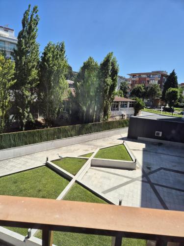 a view of a park with a bench and grass at Paradiso Dreams Hotel in Nesebar