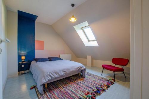 a bedroom with a bed and a red chair at Les lys in Saint-Julien-les-Villas