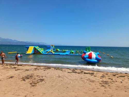 a group of people standing on a beach with at Comfort Holidays in Messini