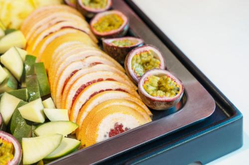 a tray of food with fruits and vegetables at Novotel Suites Nancy Centre in Nancy