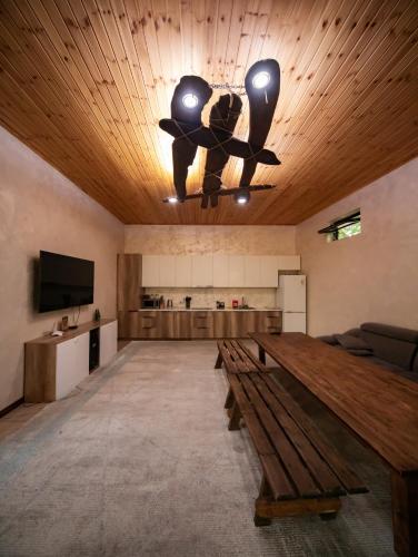 a large room with a table and a ceiling fan at Green Villa Near Bishkek in Këk-Dzhar