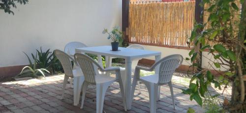 a white table and four chairs sitting around a table at Teresa in Tortolì