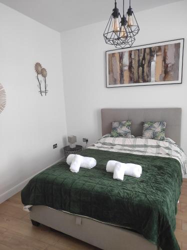 a bedroom with a bed with two pillows on it at Cosy Private Home in London with Garden in London