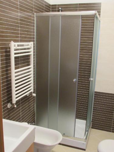 a shower in a bathroom with a toilet and a sink at Pianeta Roma 45 in Rome