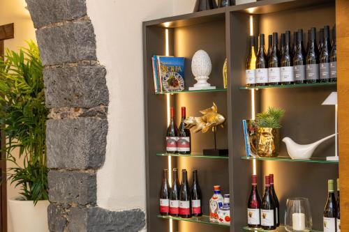 a shelf with bottles of wine on it at Feudogrande Bio Relais Hotel in Fiumefreddo di Sicilia