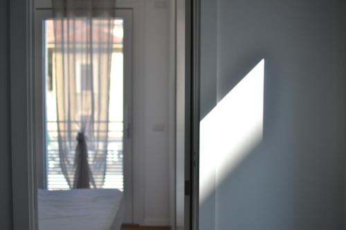 a glass door with a shadow of a dog on a balcony at Hotel Vienna in Pesaro