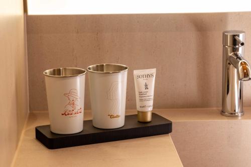 a couple of cups sitting on a shelf at Belinda Hôtel & Spa in Paris