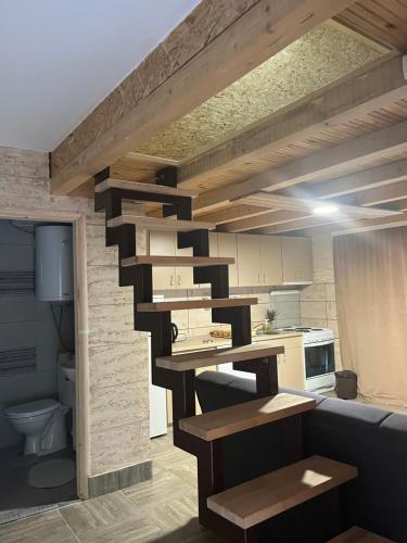 a kitchen with a spiral staircase in a room at Apartmani Visnja in Crni Vrh