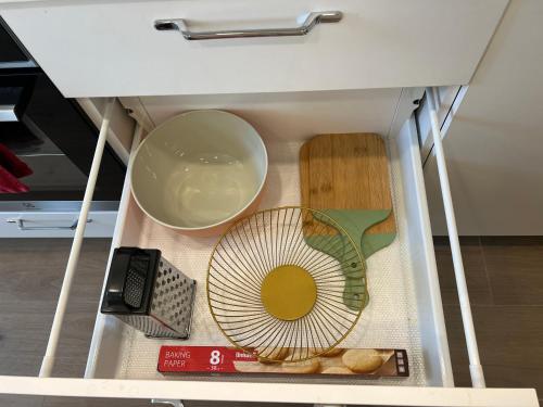 a drawer with a bowl and a fan in it at Skaidiškės Guesthouse in Skaidiškės