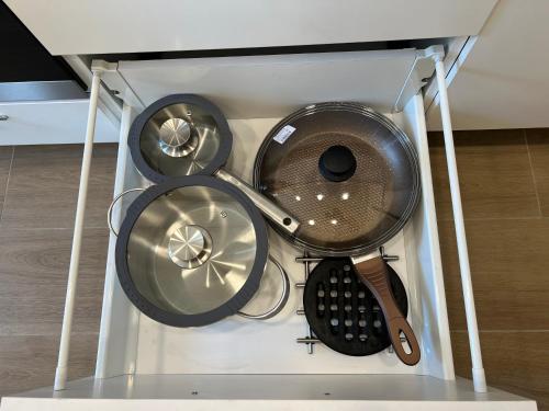 a glass display case with a bunch of kitchen utensils at Skaidiškės Guesthouse in Skaidiškės