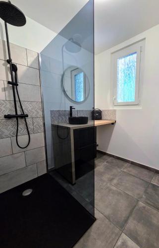 a bathroom with a sink and a mirror at L'Ombre du Hêtre in Lourdes