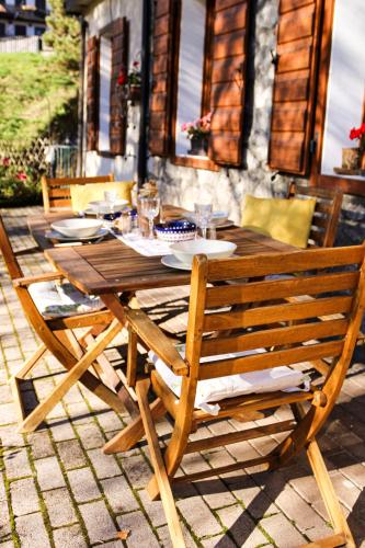 a wooden table and chair sitting on a patio at Da Bino - Vicino Pista Ciclabile in Valle di Cadore