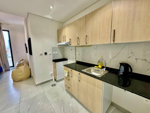 a kitchen with a sink and a counter top at Spacious unit with a terrace in Dubai