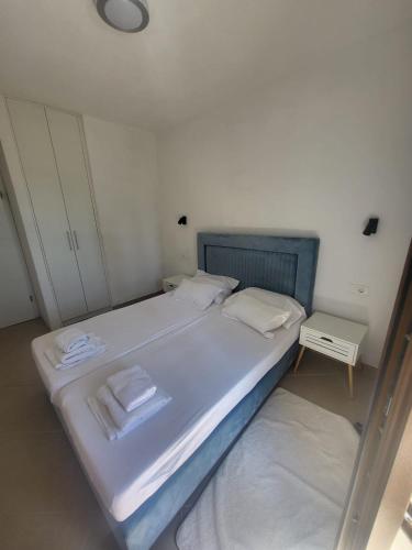a bedroom with a bed with two towels on it at Villa Dragi in Klek