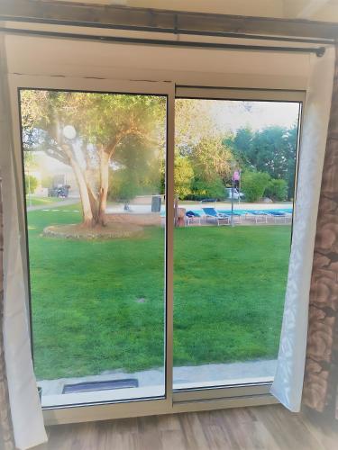 a window with a view of a field of grass at Casa Pito Pito in Alghero