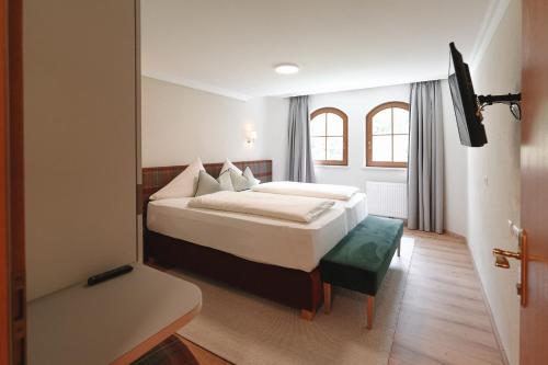a bedroom with a bed and a television in it at Alpenschlössl Boutique Appartements & Rooms in Neustift im Stubaital