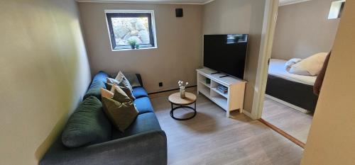 a small living room with a couch and a bed at Beautiful appartment 2 bedroom in Sandefjord