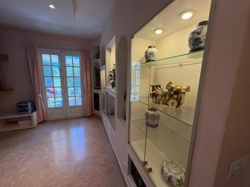 a hallway with glass shelves in a home at Villa les Faou-Anis in Le Castellet