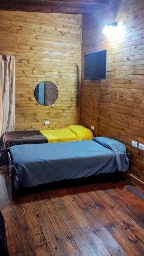 a bedroom with a bed in a wooden wall at ELLA CON El MAR in Mar del Plata