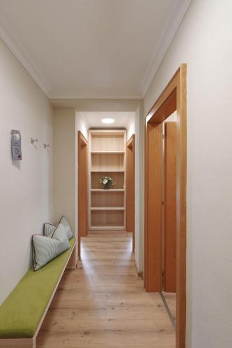 a corridor of a room with a bed and a door at Alpenschlössl Boutique Appartements & Rooms in Neustift im Stubaital
