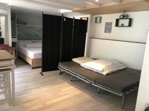 a room with a bed and a bedroom with at ORC Adventure - Les Monts du Lyonnais in Vaugneray