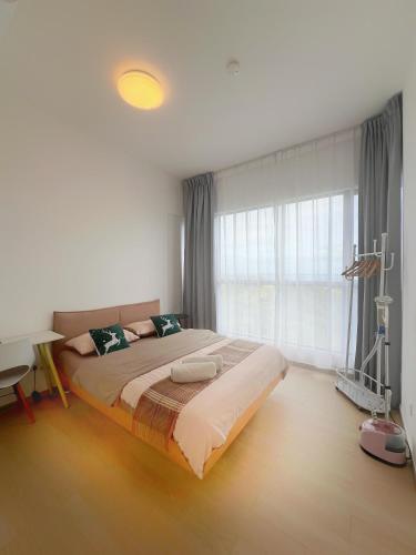 a bedroom with a large bed and a large window at Super Comfort 2R2B Luxury Seaview Sandakan in Sandakan