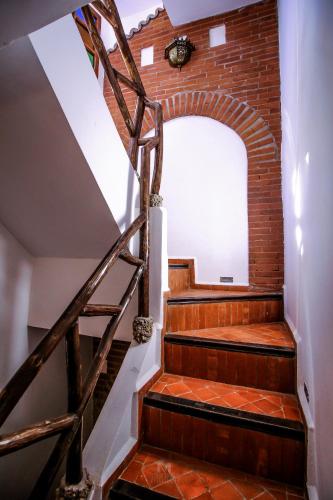 a staircase in a building with a brick wall at Riad Bab Mahrouk in Chefchaouene