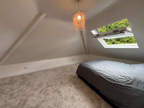 a bedroom with a bed and a window at The Bishop Retreat in London