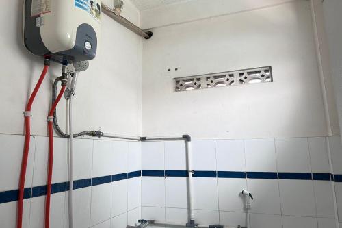 a bathroom with a shower in the corner of a room at Hotel Kinasih Yogyakarta in Yogyakarta
