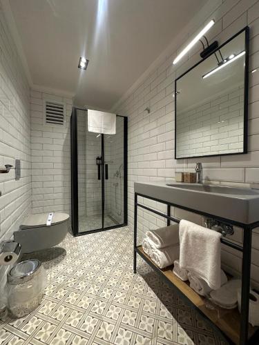 a bathroom with a sink and a toilet and a shower at Oikos Bozcaada in Bozcaada