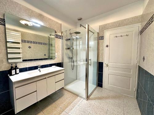 a bathroom with a shower and a sink and a mirror at Le Chauffour in Rue
