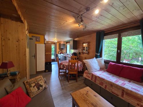 a living room with a couch and a table at Chalet la sapiniere in La Chapelle-dʼAbondance