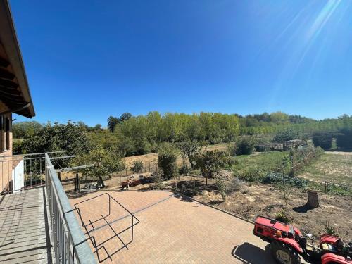 a red truck is parked on a patio at Villa di Campagna-With WIFI and Private Parking in Pecetto di Valenza