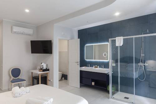 a bathroom with a shower and a sink and a toilet at B&B PierGaia in Santa Maria di Castellabate