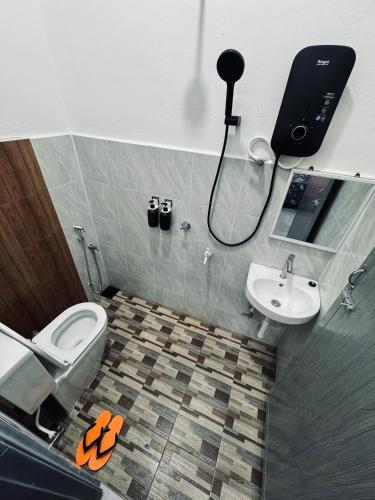 a bathroom with a toilet and a sink at Homestay CikguMa 4 - Wi-Fi in Kota Bharu
