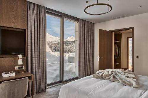 a bedroom with a bed with a view of a mountain at Hotel GRACE LA MARGNA ST MORITZ in St. Moritz