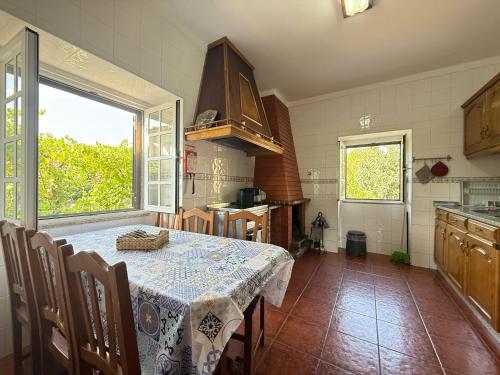 a kitchen with a table with a table cloth on it at Casa dos Patricios in Terras de Bouro