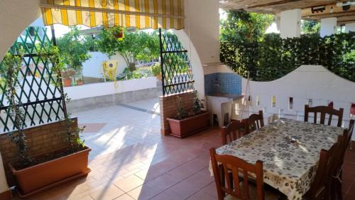 a dining room with a table and some plants at Case Vacanze Giardino in Parghelia
