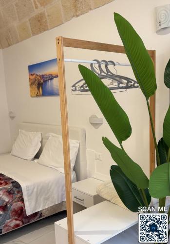 a bedroom with a bunk bed and a plant at Affittacamere Marì in Polignano a Mare