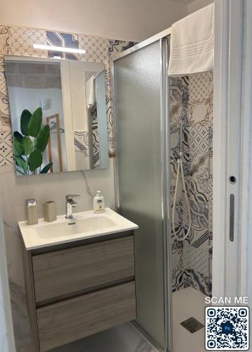 a bathroom with a sink and a shower at Affittacamere Marì in Polignano a Mare