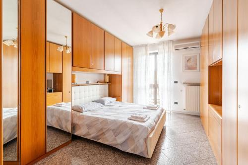 a bedroom with a bed and a large mirror at Penthouse with Terrace - Private Parking & WIFI in Pecetto di Valenza