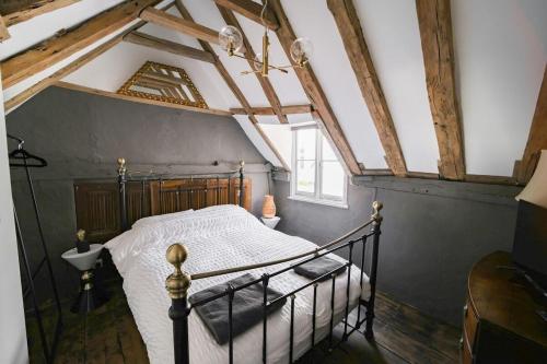 a bedroom with a bed in a room with wooden ceilings at Historic, Jacobean House, Old Town Hastings in Hastings