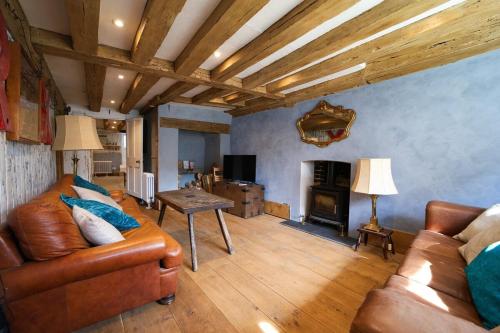 a living room with a couch and a fireplace at Historic, Jacobean House, Old Town Hastings in Hastings