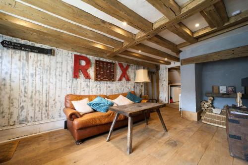 a living room with a couch and a table at Historic, Jacobean House, Old Town Hastings in Hastings