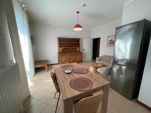 a kitchen with a wooden table and a refrigerator at Hotel Clementi in Salice Terme