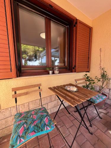 a wooden table and two chairs and a window at Noa & Dan in Koper