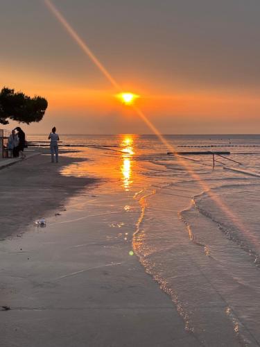 a man standing on the beach watching the sunset at Noa & Dan in Koper